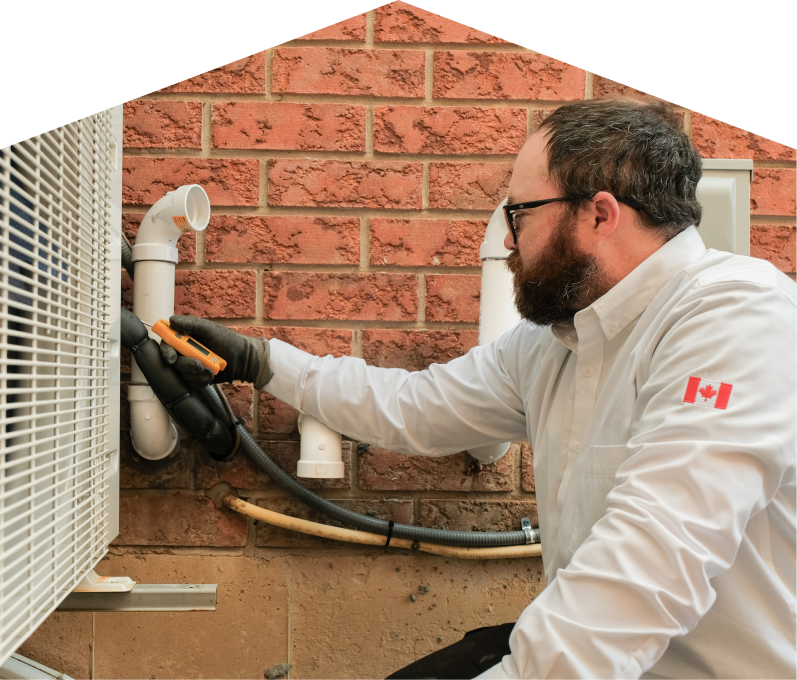 Haven Home HVAC specialist checking insulated piping on a heat pump unit beside a brick wall during a diagnostic service. Haven Home HVAC specialist checking insulated piping on a heat pump unit beside a brick wall during a diagnostic service.