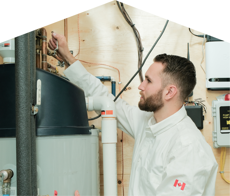 Haven Home water heater specialist adjusts piping on a large residential unit during a repair service, with exposed wood paneling and mounted utility components in the background. Haven Home water heater specialist adjusts piping on a large residential unit during a repair service, with exposed wood paneling and mounted utility components in the background.