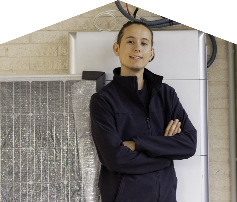 Haven Home specialist standing confidently with arms crossed beside newly delivered system components, including a wrapped panel and wall-mounted utility unit. Haven Home specialist standing confidently with arms crossed beside newly delivered system components, including a wrapped panel and wall-mounted utility unit.