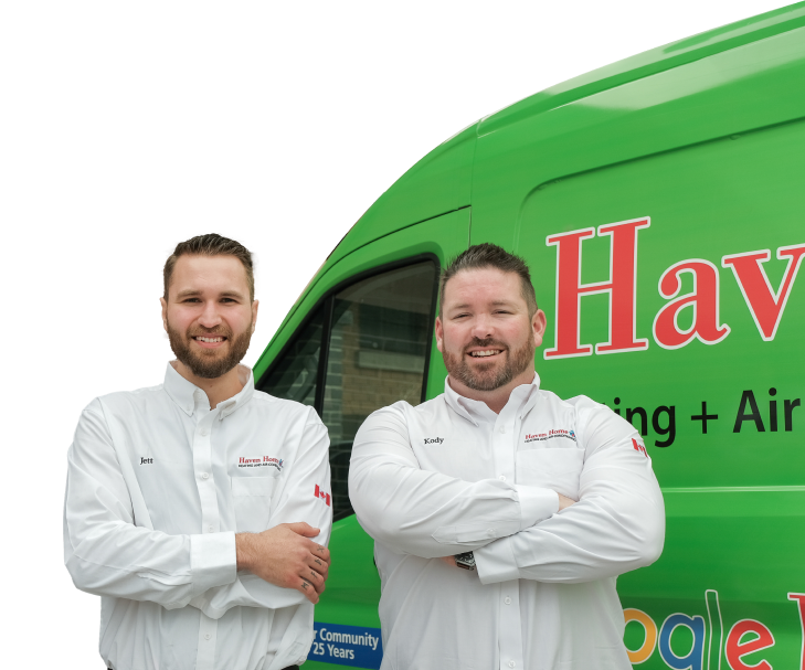 Two Haven Home technicians smiling in front of their green service van, wearing issued jackets during an on-site consultation.